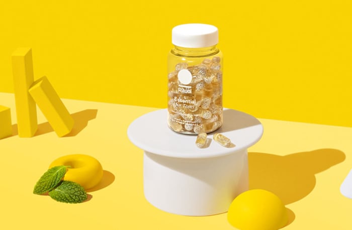 A bottle of the Ritual Essential for Teens multivitamin against a yellow background.